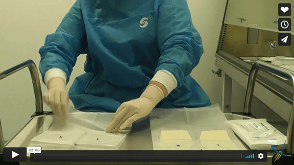 Donning Double HD Sterile Gloves in the compounding pharmacy.